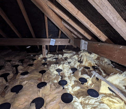 Loft storage insulation in progress, with insulation material fitted between joists