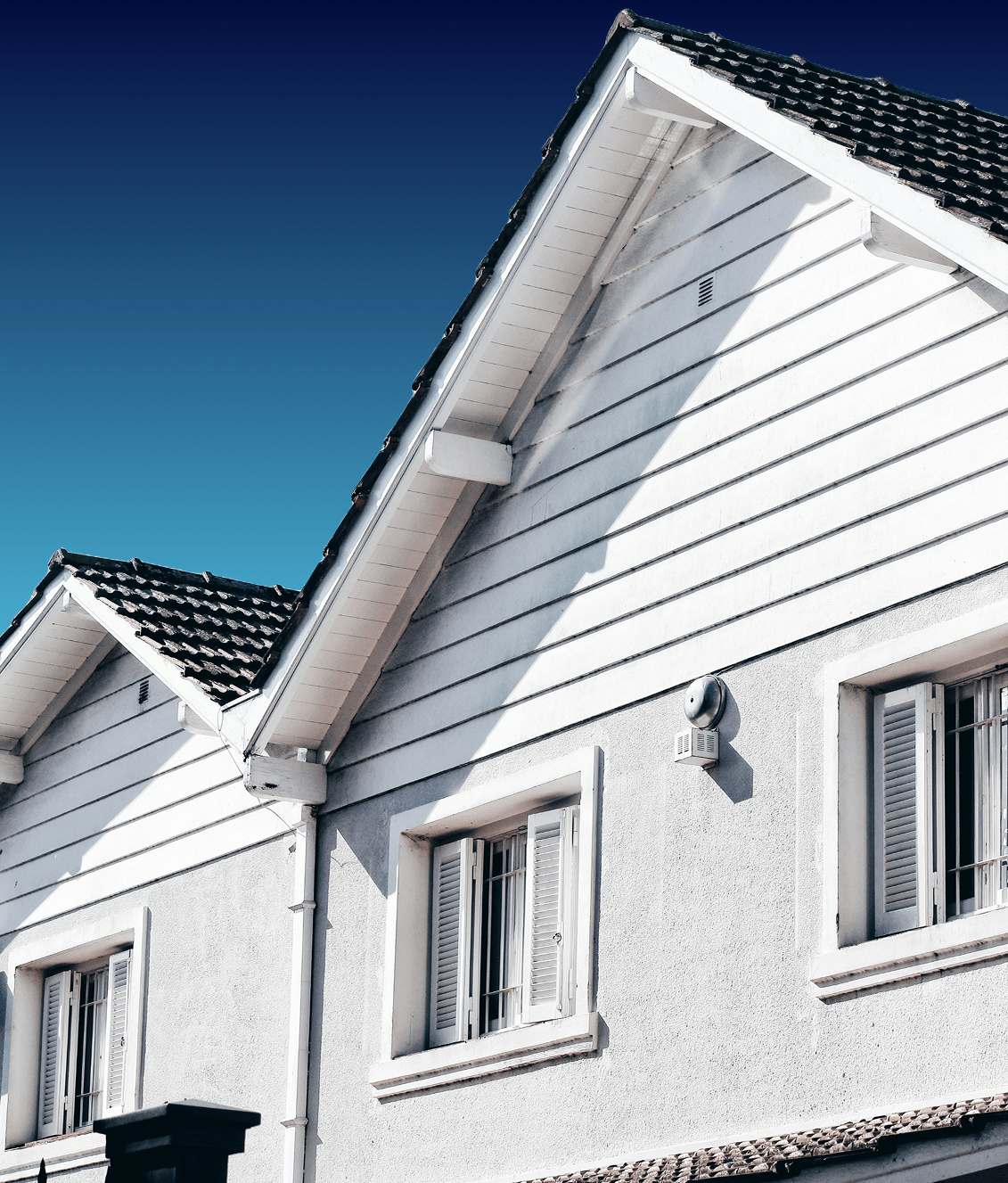 White house with a focus on the roof, showcasing potential loft storage and boarding solutions